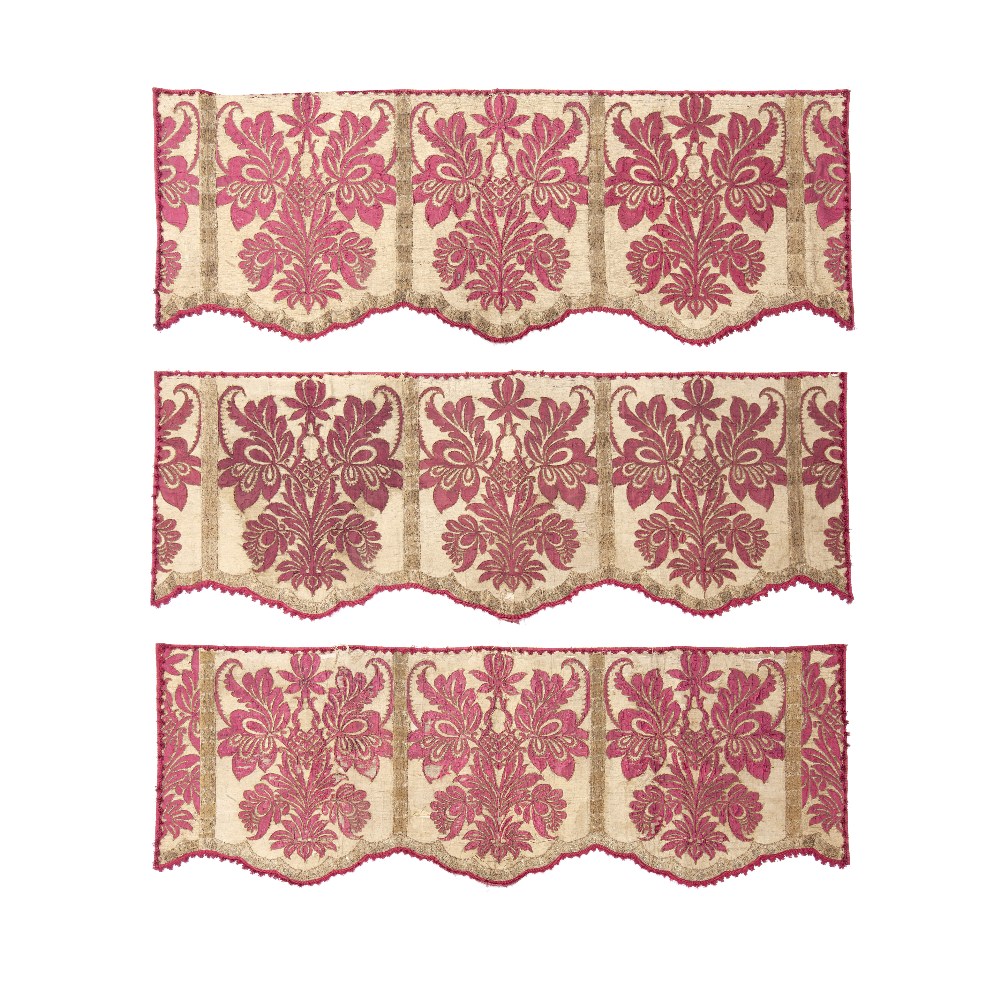 A set of three red damask appliqu&#233; pelmets Late 17th century, probably Spanish