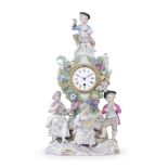 A late 19th century Continental porcelain figural mantel timepiece in the Meissen style