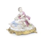 A gilt bronze mounted Meissen style porcelain figural group of two putti the porcelain probably ...