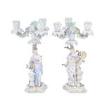 A pair of late 19th/early 20th century Meissen porcelain figural three-light candelabra in the 1...