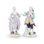 A matched pair of late 19th century Meissen porcelain figures of a courtly couple, probably outs...