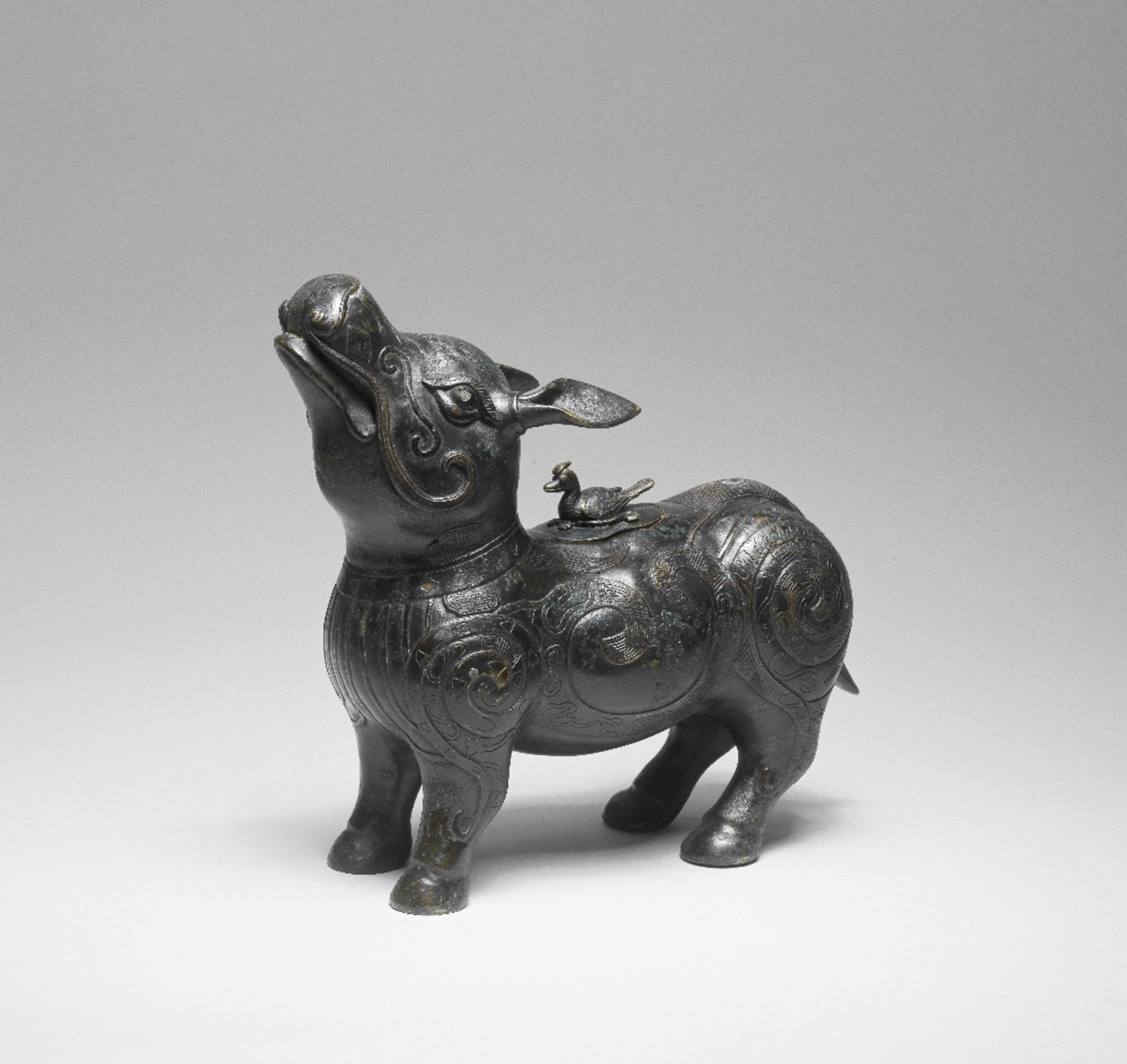 A RARE GOLD AND SILVER-INLAID BRONZE TAPIR-SHAPED VESSEL AND COVER, XIZUN Ming/early Qing Dynasty...