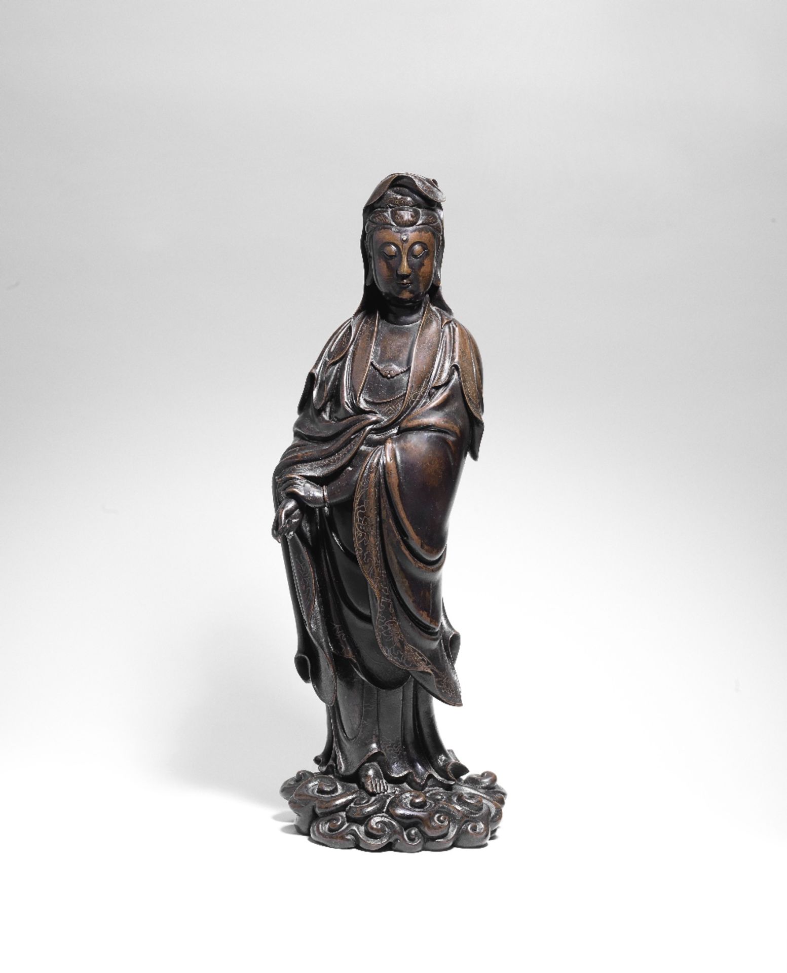 A RARE AND IMPORTANT SILVER-INLAID BRONZE FIGURE OF GUANYIN He Chaozong seal mark, late Ming Dyn...