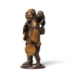 A WOOD OKIMONO (TABLE ORNAMENT) OF A SARUMAWASHI (MONKEY TRAINER) Meiji era (1868-1912), late 19...