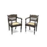 Two carved ebony chairs Ceylon, 1820-25, incorporating panels from the Coromandel Coast or Ceylo...