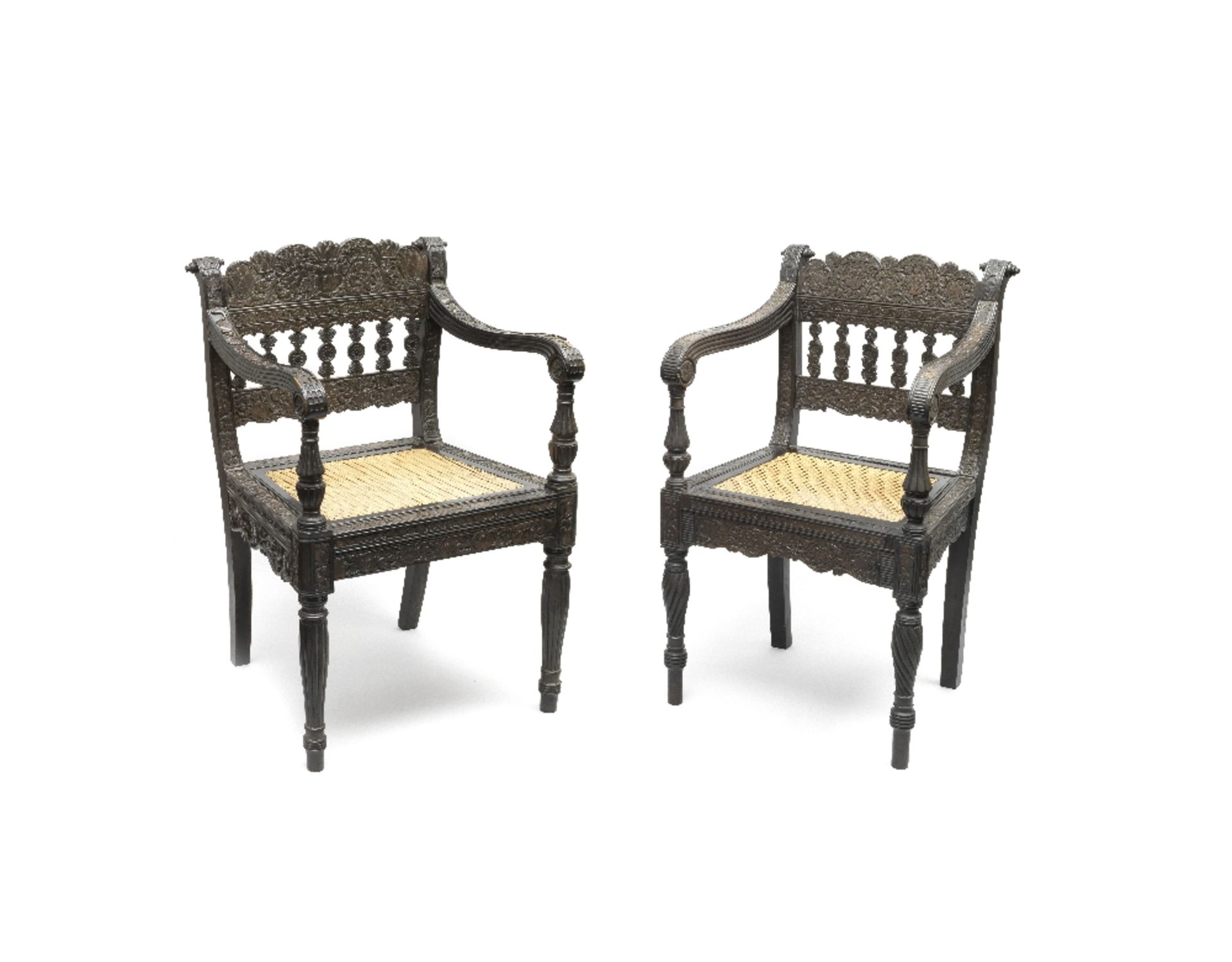 Two carved ebony chairs Ceylon, 1820-25, incorporating panels from the Coromandel Coast or Ceylo...