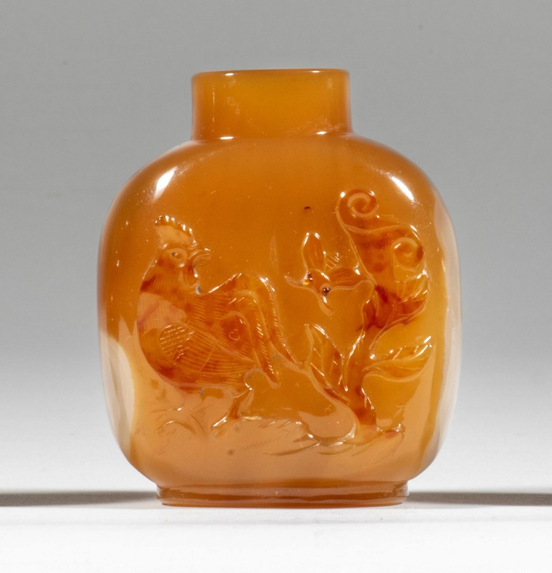 A chalcedony agate snuff bottle 1820-1900 Cockerel and bee decoration on one side, with white cl...