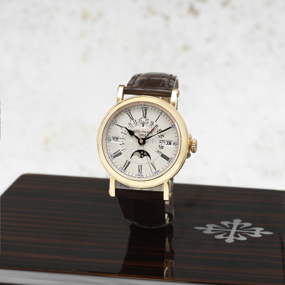 Patek Philippe. A fine 18K rose gold automatic perpetual calendar wristwatch with moon phase, le...