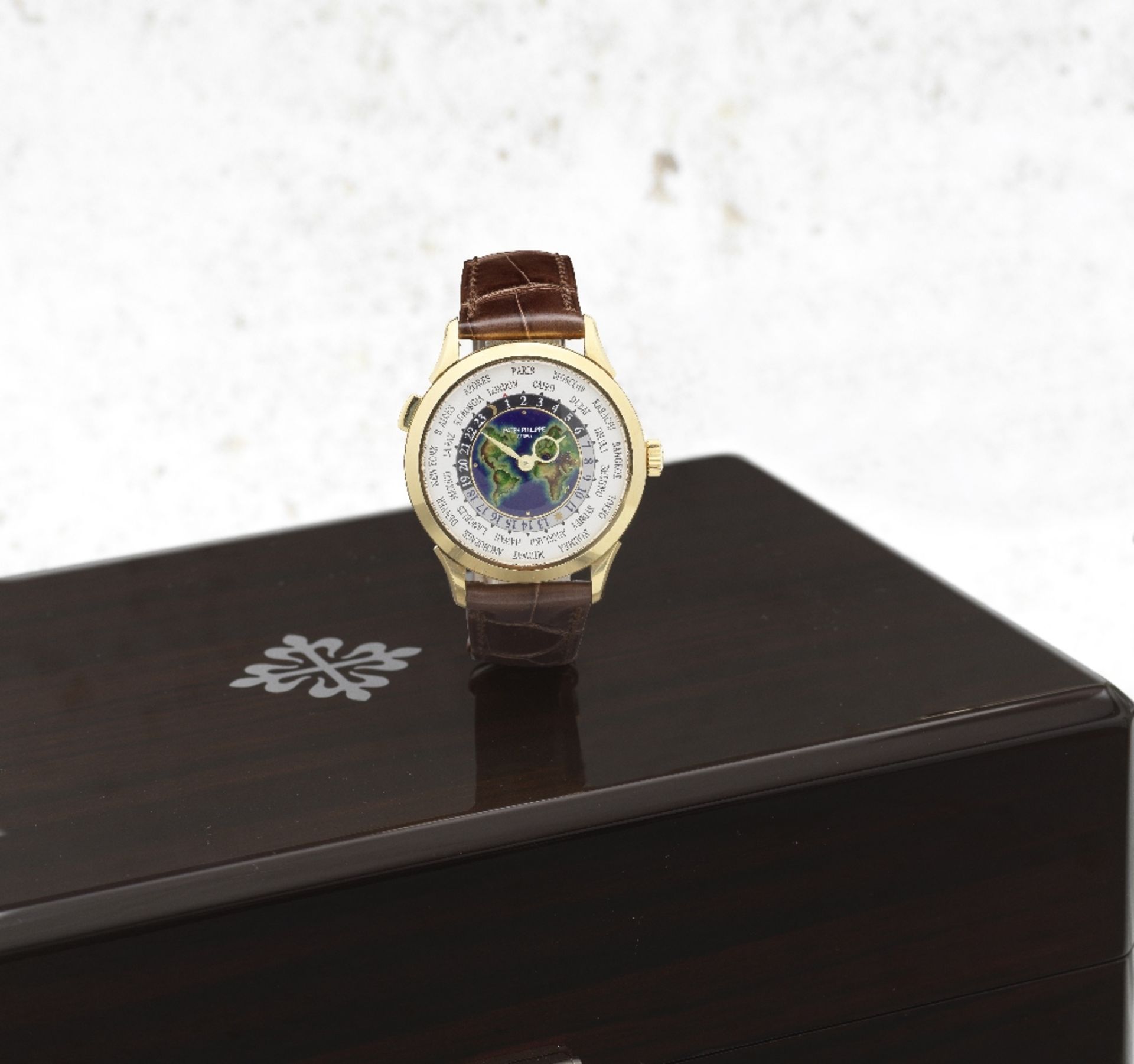 Patek Philippe. A fine and rare 18K rose gold automatic wristwatch with world time indication an...