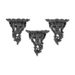 A set of three Italian carved and ebonised wall brackets (3)