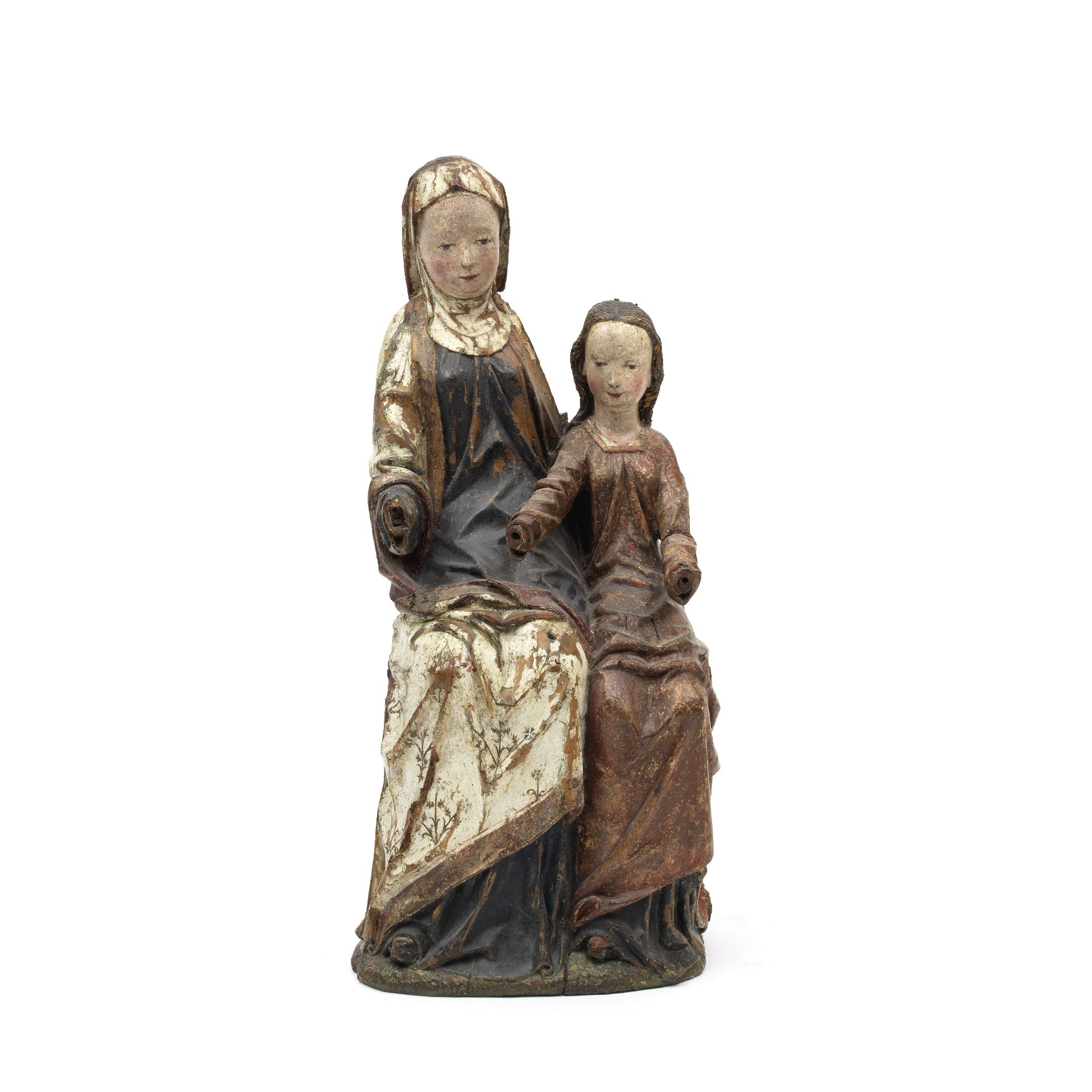 A carved wood and polychrome decorated figural group of St. Anne teaching Mary Probably South G...