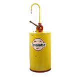 A large Essolube Motor Oil drum dispenser,