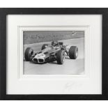 A framed photograph of Graham Hill in the Lotus 59B,