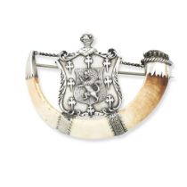 A white metal mounted boar tusk clan brooch