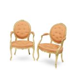 A pair of George III giltwood open armchairs in the French taste (2)