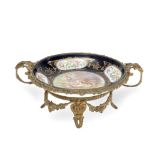 A late 19th/early 20th century French gilt bronze mounted porcelain plate in the Serves style
