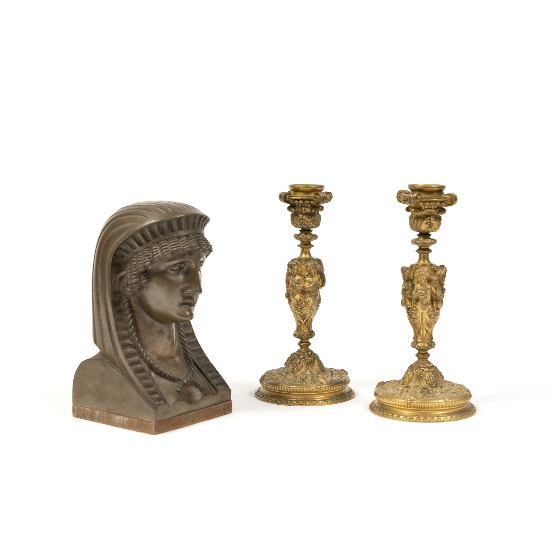 A pair of 19th century bronze candlesticks and a similar period bust term bronze mount of a Phoe...