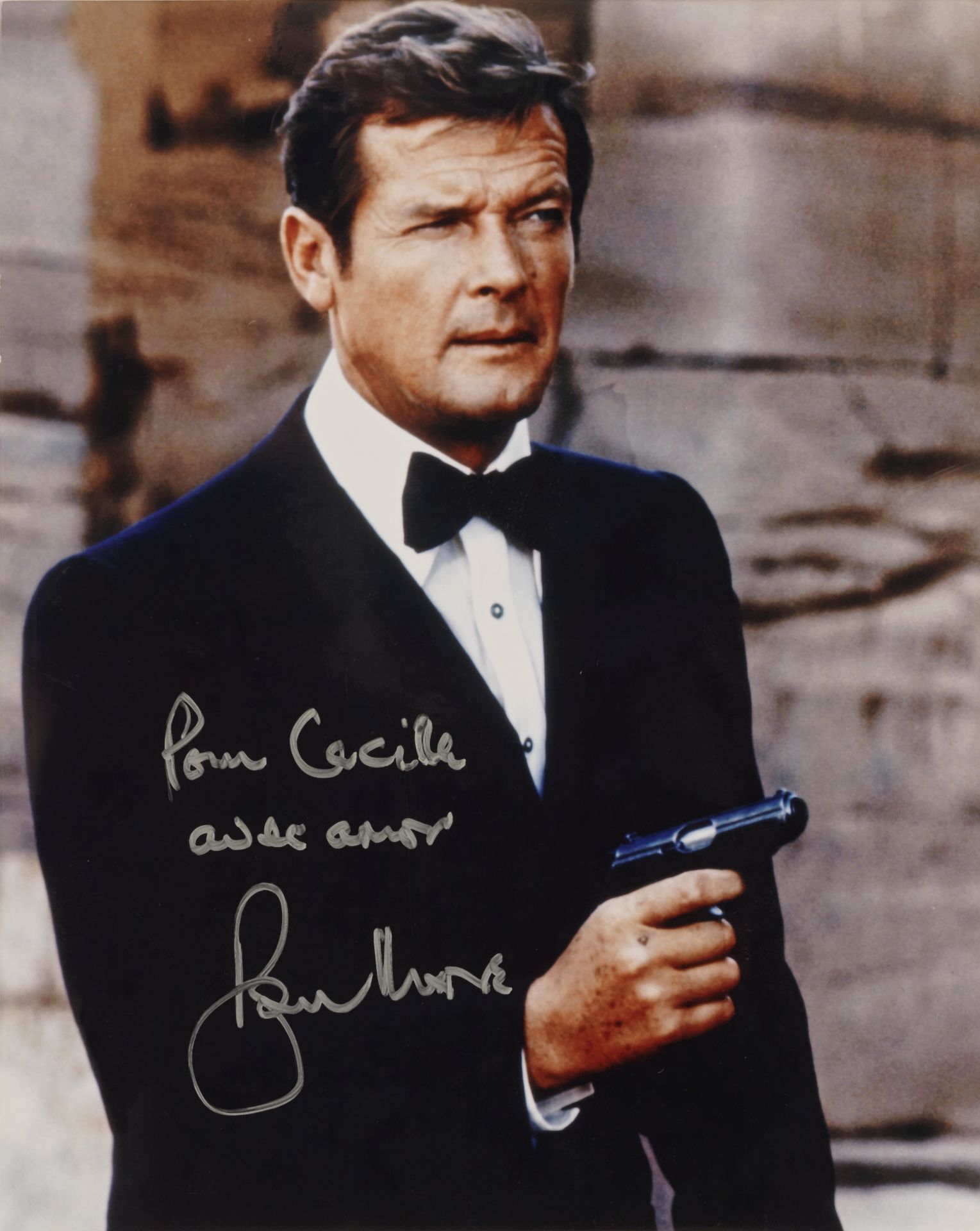 A signed colour photograph of Sir Roger Moore as James Bond in The Spy Who Loved Me