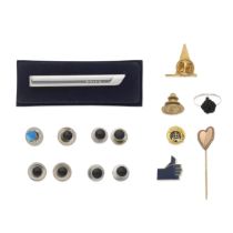 A collection of ephemera including decorative lapel pins, tie pins, studs, commemorative coins a...