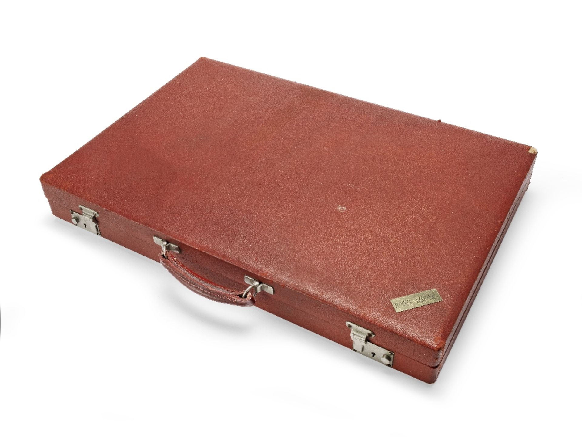 A large red simulated leather backgammon case belonging to Sir Roger Moore