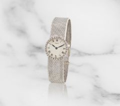 Piaget. A lady's 18K white gold and diamond set manual wind bracelet watch Piaget. Montre bracel...