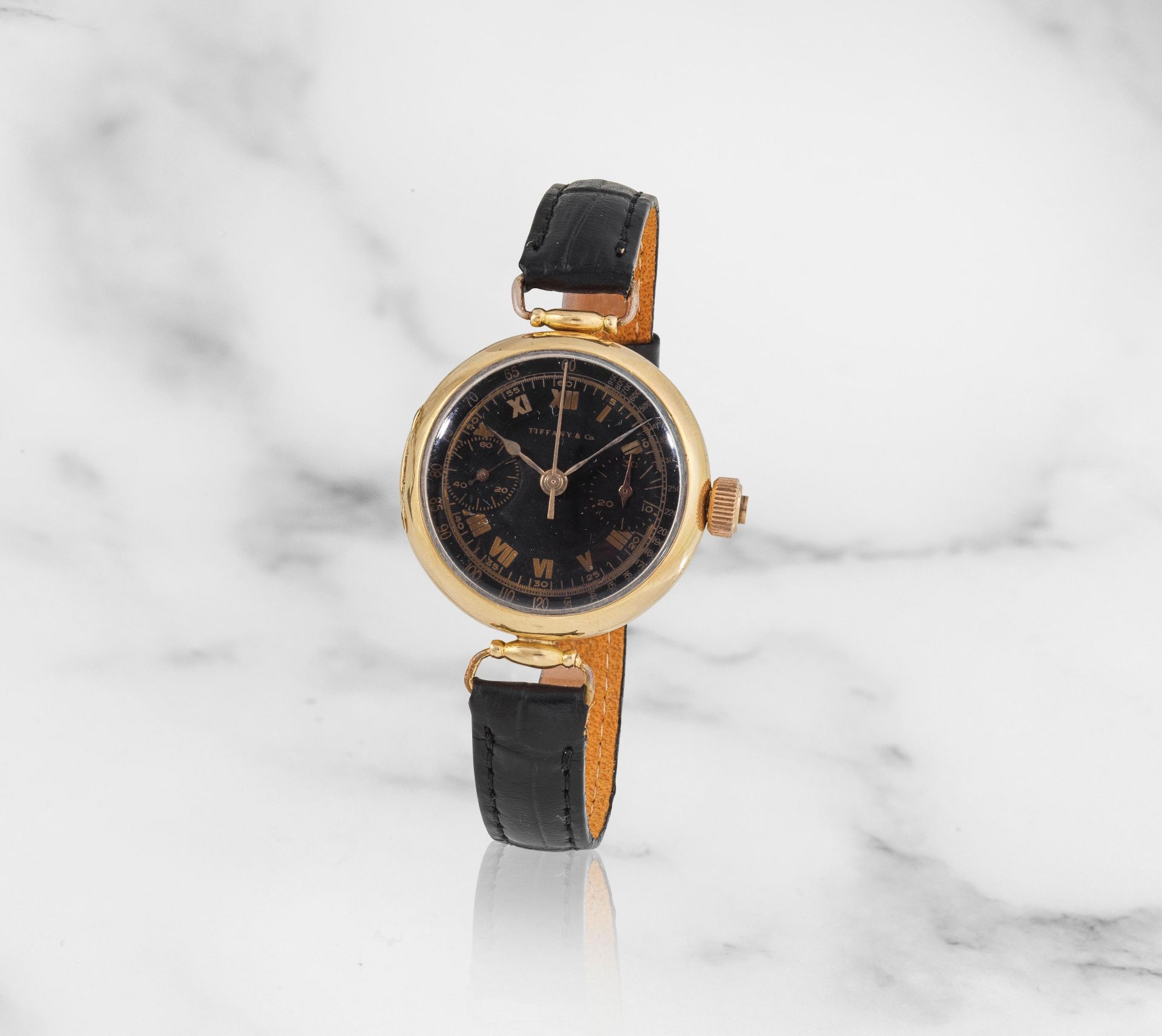 Retailed by Tiffany & Co. An 18K gold manual wind single button chronograph wristwatch Distribu&...