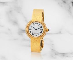 Cartier. A lady's 18K gold and diamond set manual wind bracelet watch Cartier. Montre bracelet d...