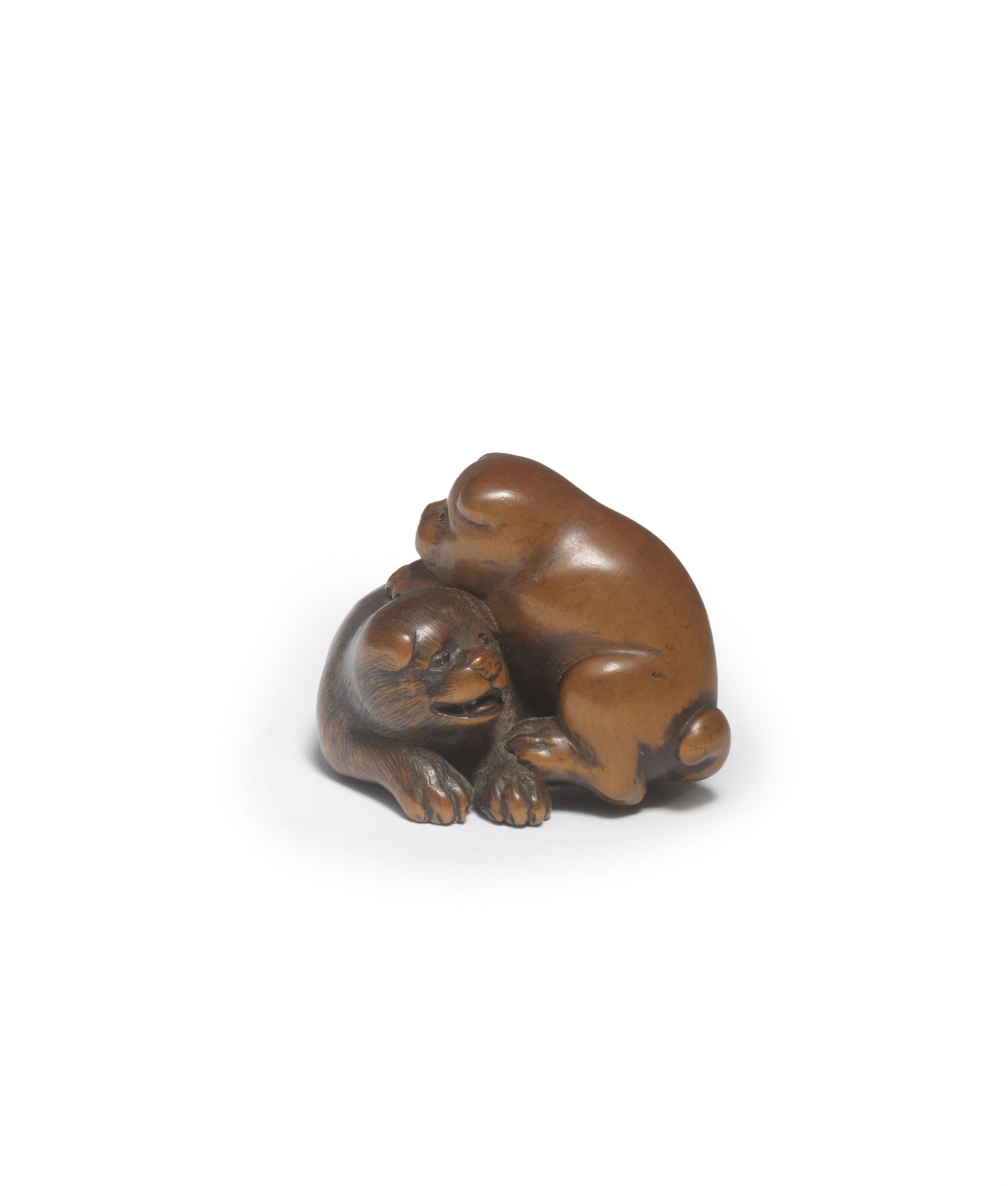 A WOOD NETSUKE OF TWO PUPPIES By Masanao, Ise, Yamada, Edo period (1615-1868), mid-19th century