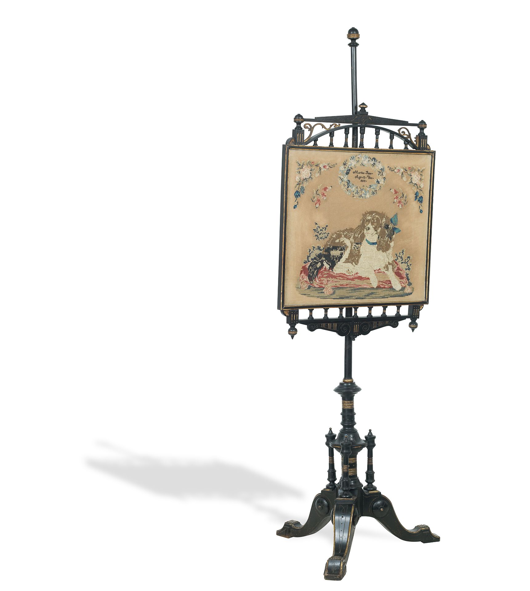 A late 19th century aesthetic style needlepoint pole screen worked with a depiction of a Spaniel