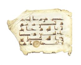 A leaf from a manuscript of the Qur'an written in kufic script on vellum Near East or North Afri...