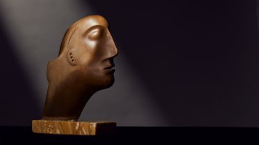 Henry Moore O.M., C.H. (British, 1898-1986) Head 17.7 cm. (7 in.) high (including the marble bas