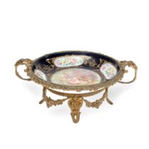 A late 19th/early 20th century French gilt bronze mounted porcelain plate in the Serves style