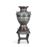 A late 19th/early 20th century champlevé enamelled and patinated bronze urn together with a...
