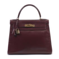 Hermès: a Rouge H Box Leather Retourne Kelly 28 1976 (includes padlock, keys, cloche and du...