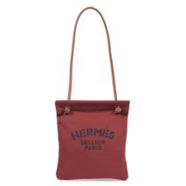 Hermès: a Rouge H and Gold Aline Grooming Bag 2022 (includes dust bag)