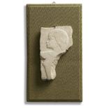 An Egyptian limestone relief fragment with male head