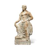 A Boeotian terracotta female figure with her foot on a stool