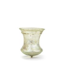 A Roman green glass bell beaker