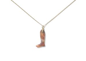 An Egyptian carnelian pendant of a leg