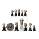 Eleven Greek and Roman terracotta heads and a black-glazed roundel 12