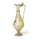 A large Roman pale green glass piriform jug