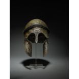 An important Etruscan bronze Chalcidian-type helmet, with silver appliqu&#233;s