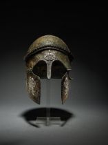 An important Etruscan bronze Chalcidian-type helmet, with silver appliqu&#233;s