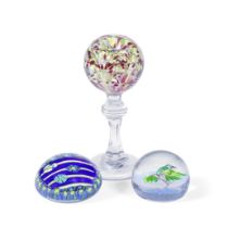 A glass paperweight 'wig stand' and two paperweights, late 19th and 20th centuries