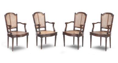 A set of four late 18th/19th century French caned open armchairs