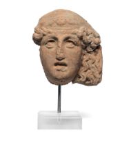 An Etruscan terracotta female face fragment