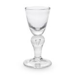 An early heavy baluster wine glass, circa 1700-10