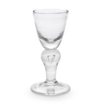 An early heavy baluster wine glass, circa 1700-10