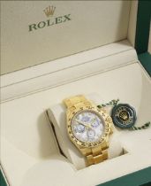 Rolex. A fine and rare 18K gold diamond set automatic chronograph bracelet watch with mother of ...