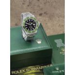 Rolex. A stainless steel automatic calendar bracelet watch with 'flat 4' bezel insert Submarine...
